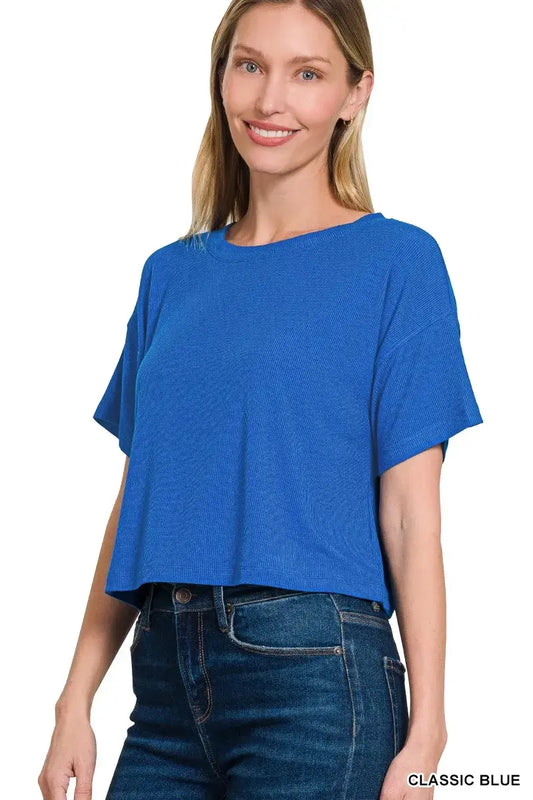 Model wearing a classic blue Zenana ribbed round-neck crop t-shirt with high-waisted jeans.
