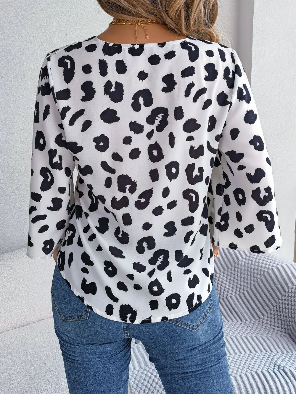 Back view of Tied Button Up Leopard V-Neck Blouse featuring bold leopard print and 3/4 sleeves.