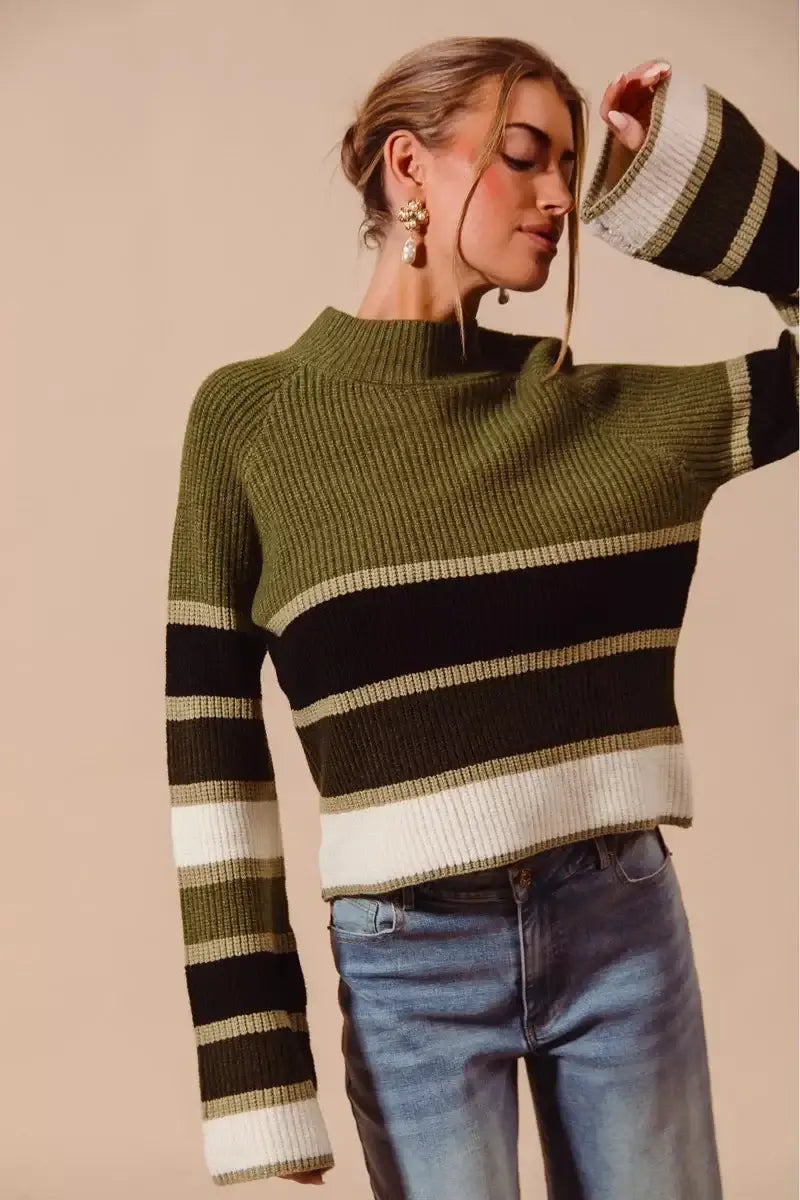 Model wearing the SO ME multi color striped mock neck sweater with bold stripes and modern design paired with jeans.