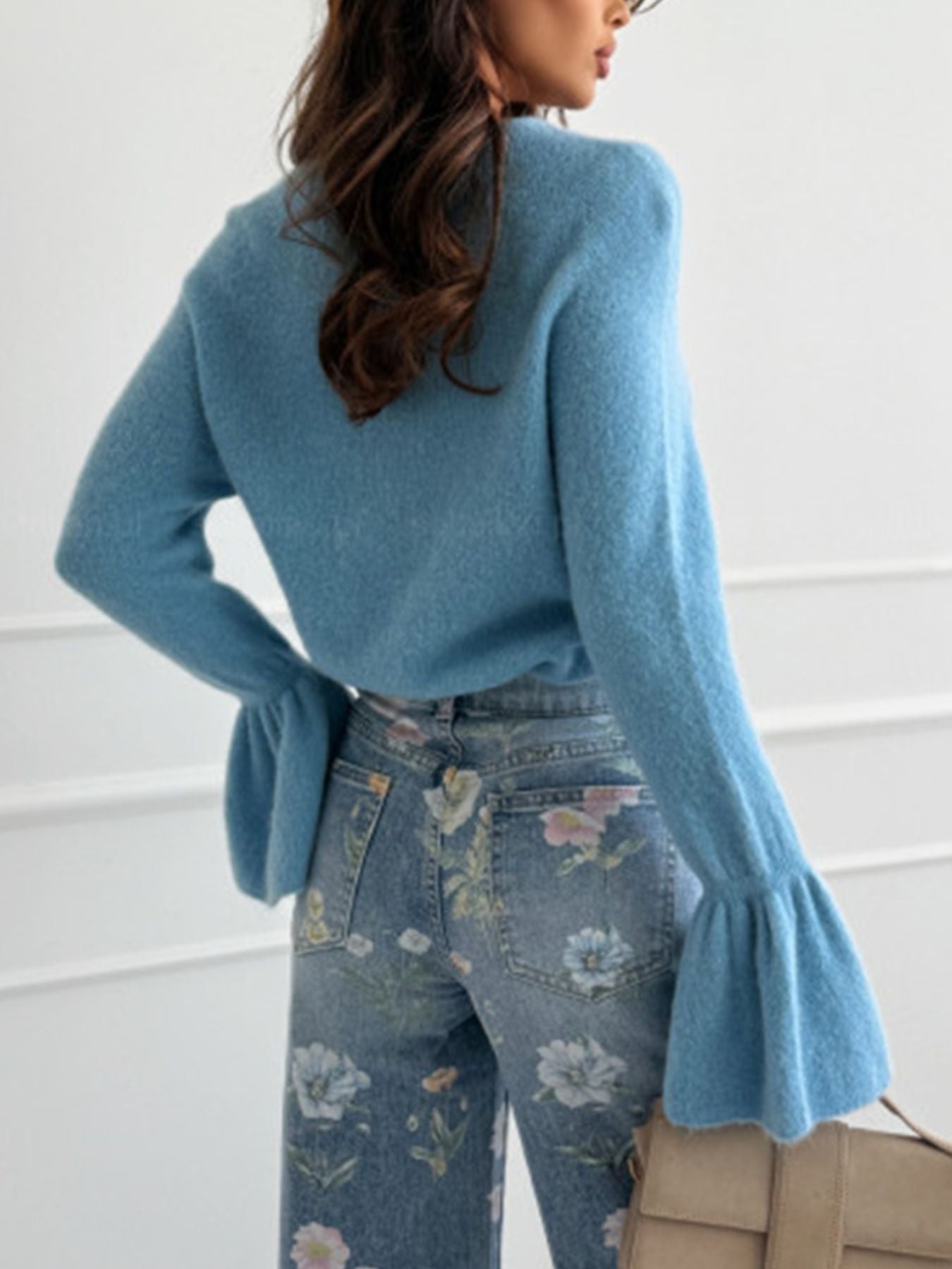 Round Neck Flounce Sleeve Sweater in blue worn with floral jeans, showcasing stylish flounce sleeves and a cozy design.