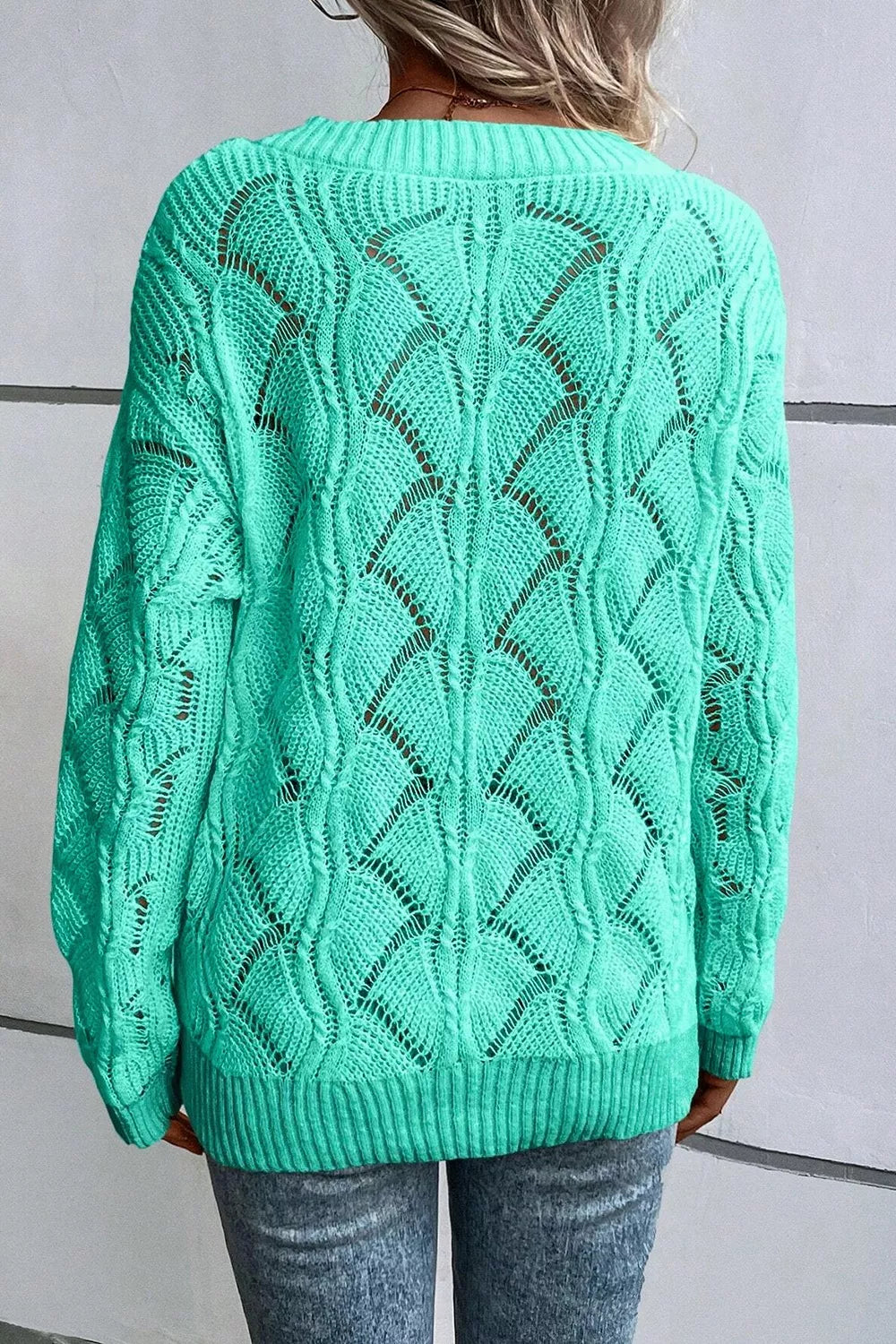 Back view of the Elegant Texture V-Neck Knit Top, a women's cable knit sweater in mint green with openwork design.