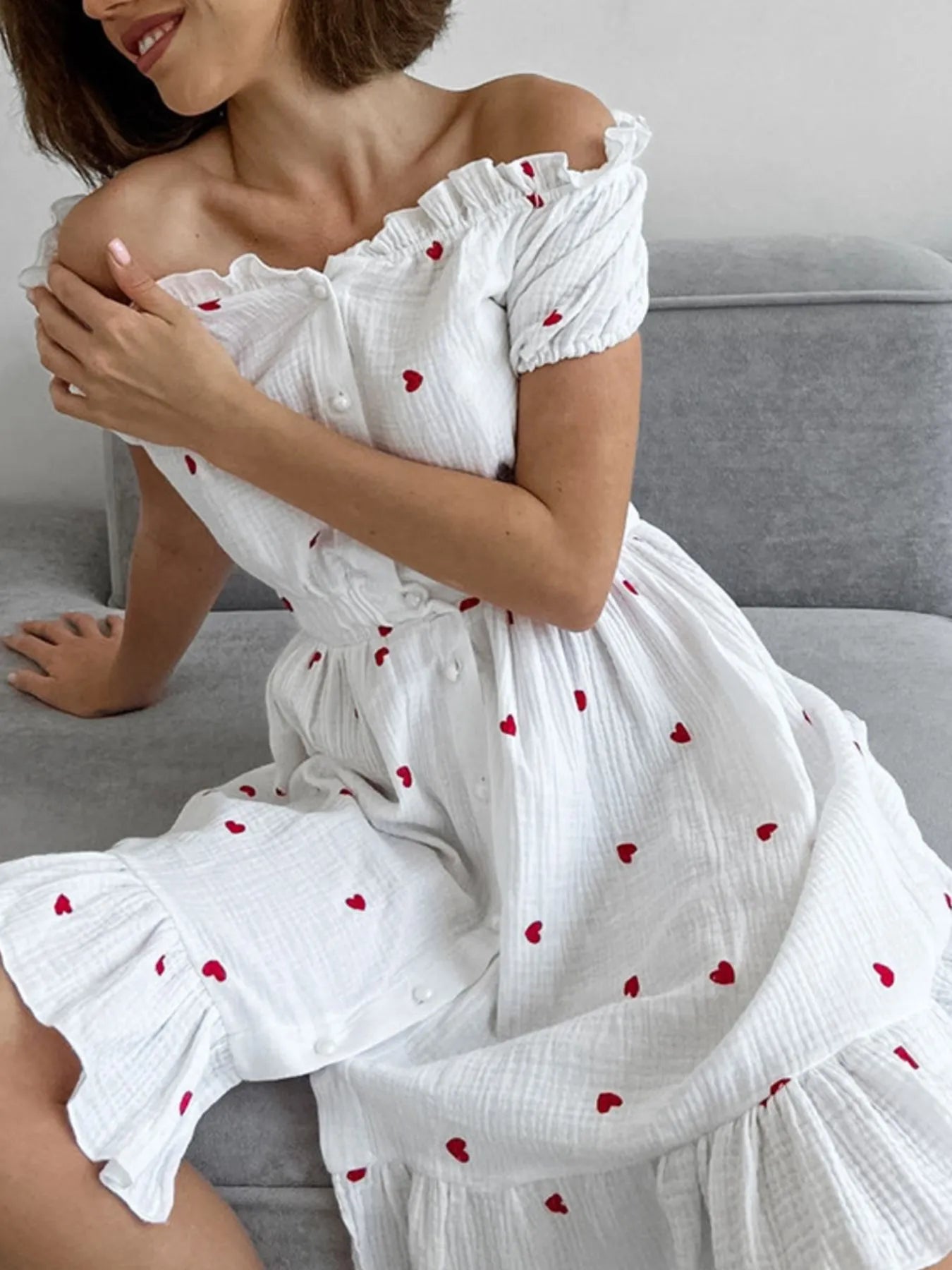 Heart Printed Off-Shoulder Ruffle Mini Dress styled on a model, featuring red hearts and frill details.