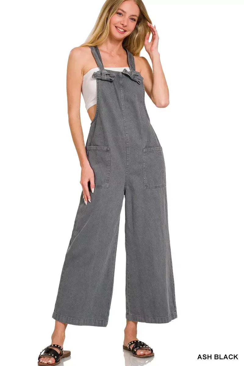 Zenana Washed Knot Strap Pockets Jumpsuit in ash black worn by a model, featuring adjustable knot straps and side pockets.