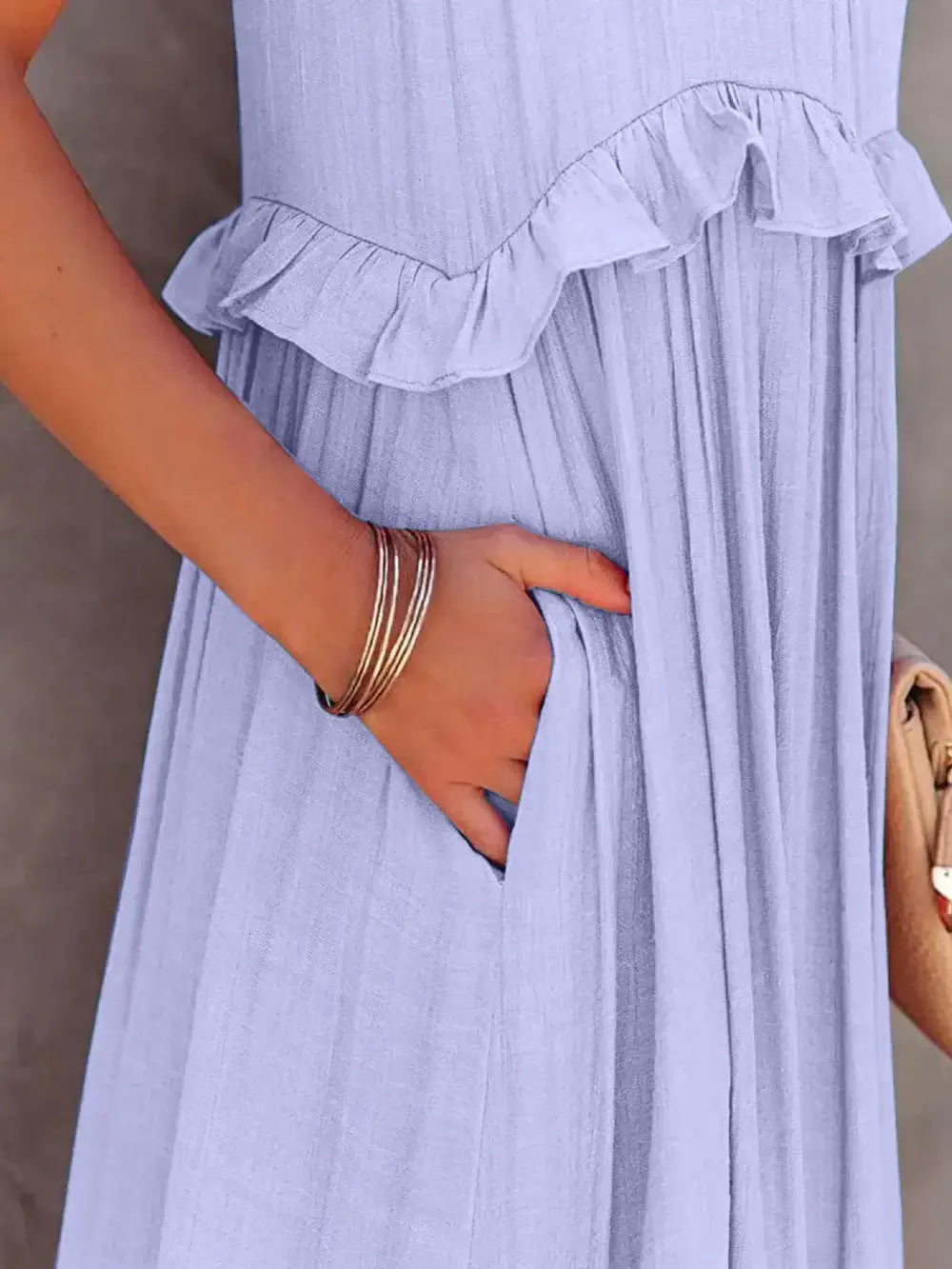 Close-up of Ruffled Sleeveless Tiered Maxi Dress with Pockets highlighting the ruffle detail and hidden pocket.