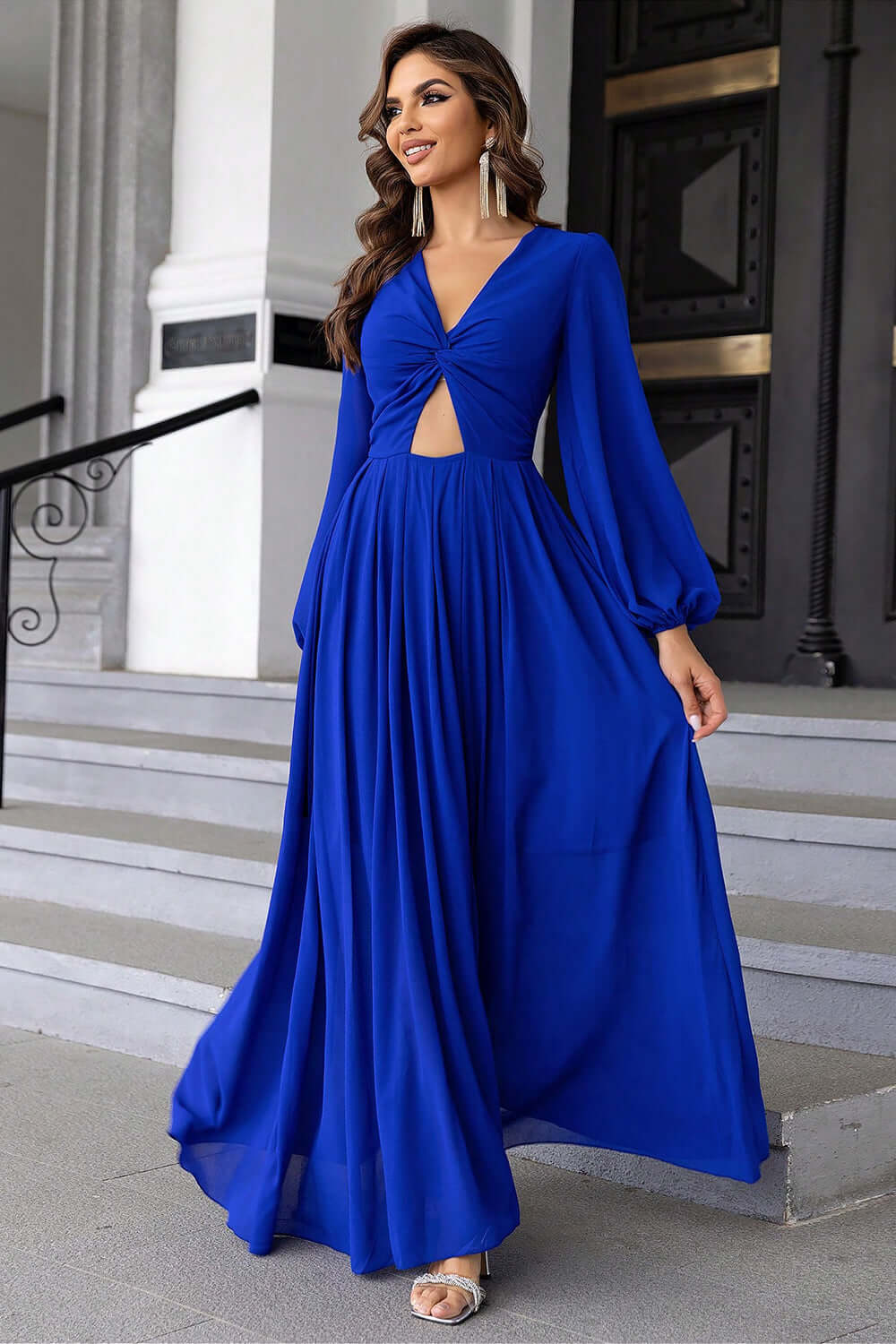 Model wearing a Twist Front Cutout Long Sleeve Dress in blue, showcasing a chic cutout and elegant long sleeves.
