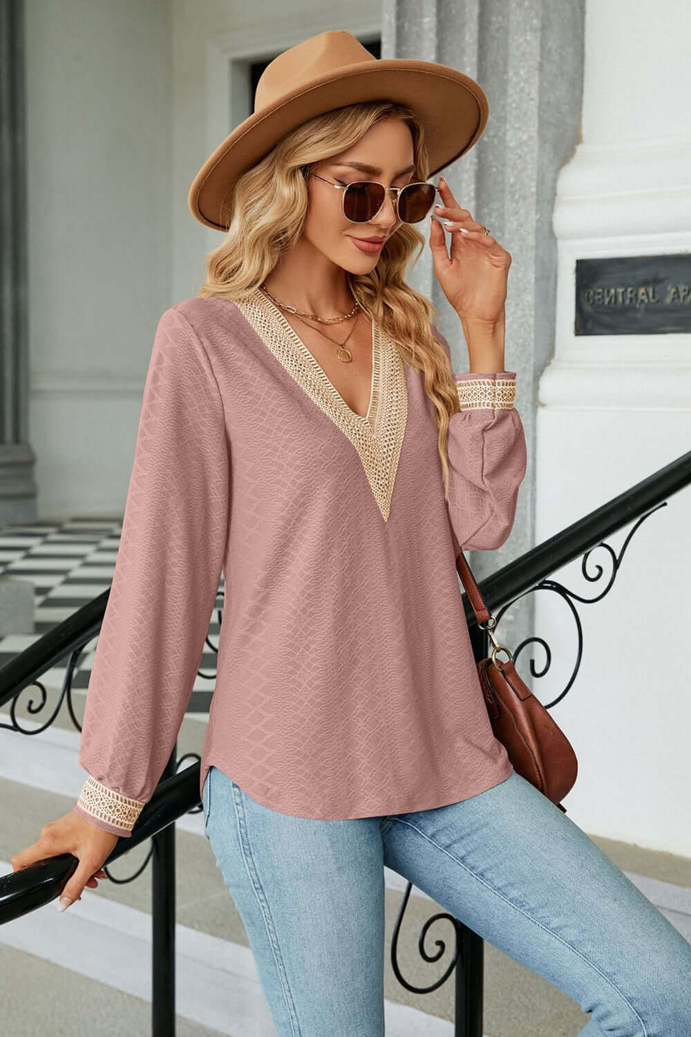 Woman wearing a V-Neck Long Sleeve Blouse with a stylish hat and sunglasses, showcasing casual elegance.