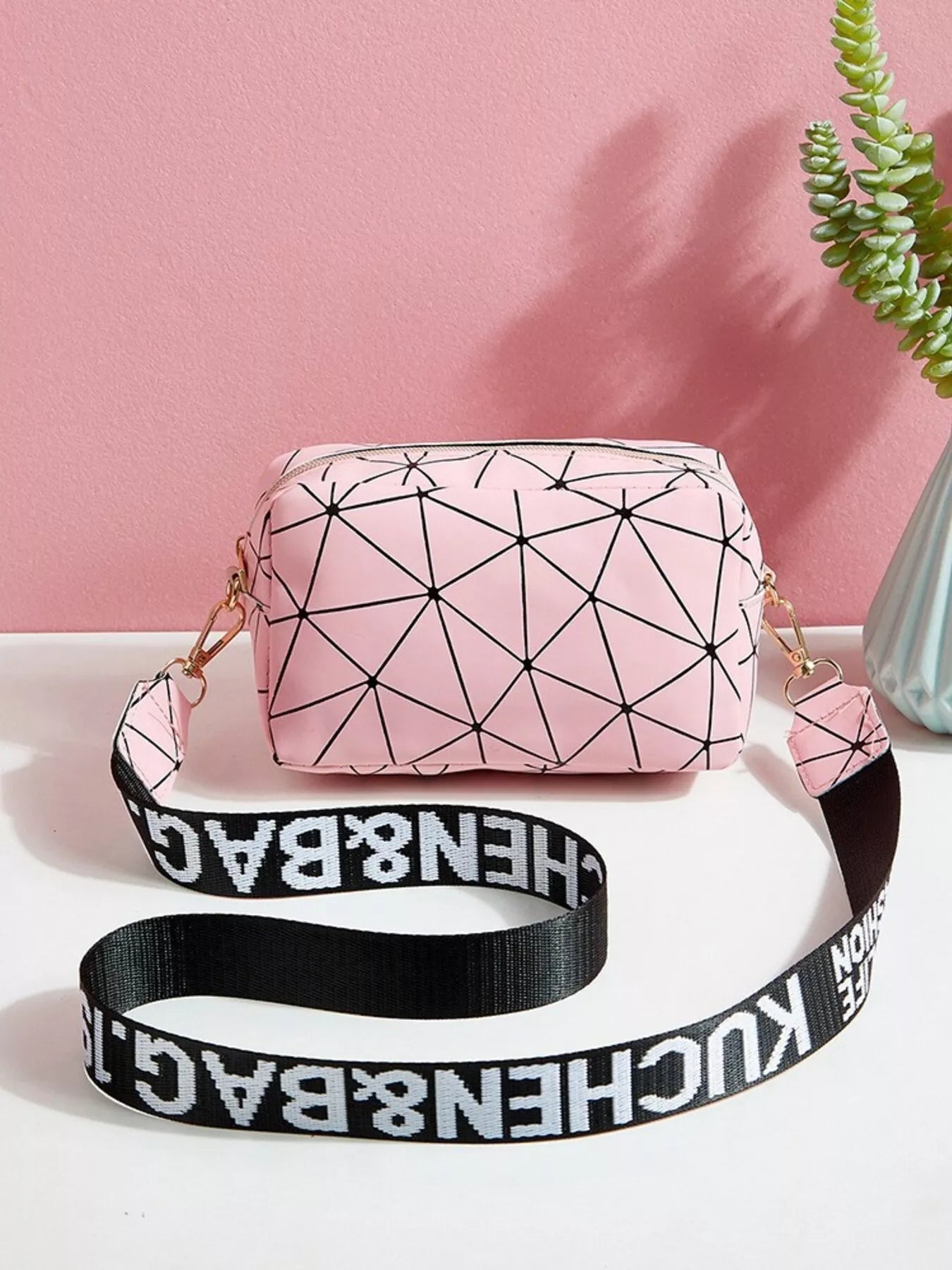 Geometric Pattern Crossbody Bag in pink with black strap, perfect for modern everyday style.