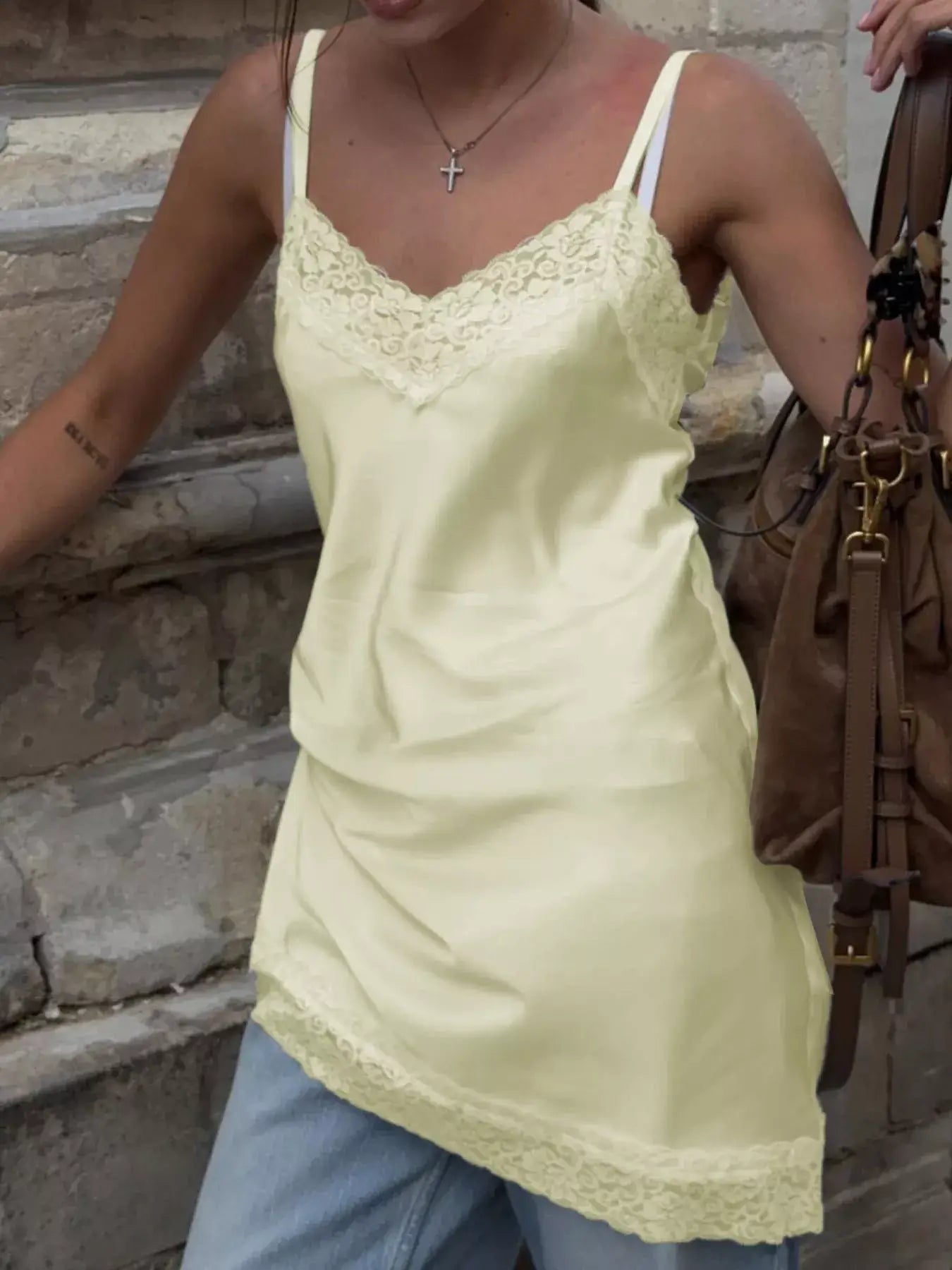 Lace Detail V-Neck Cami in soft yellow with delicate lace trim, worn casually with jeans, adding femininity to a stylish look.