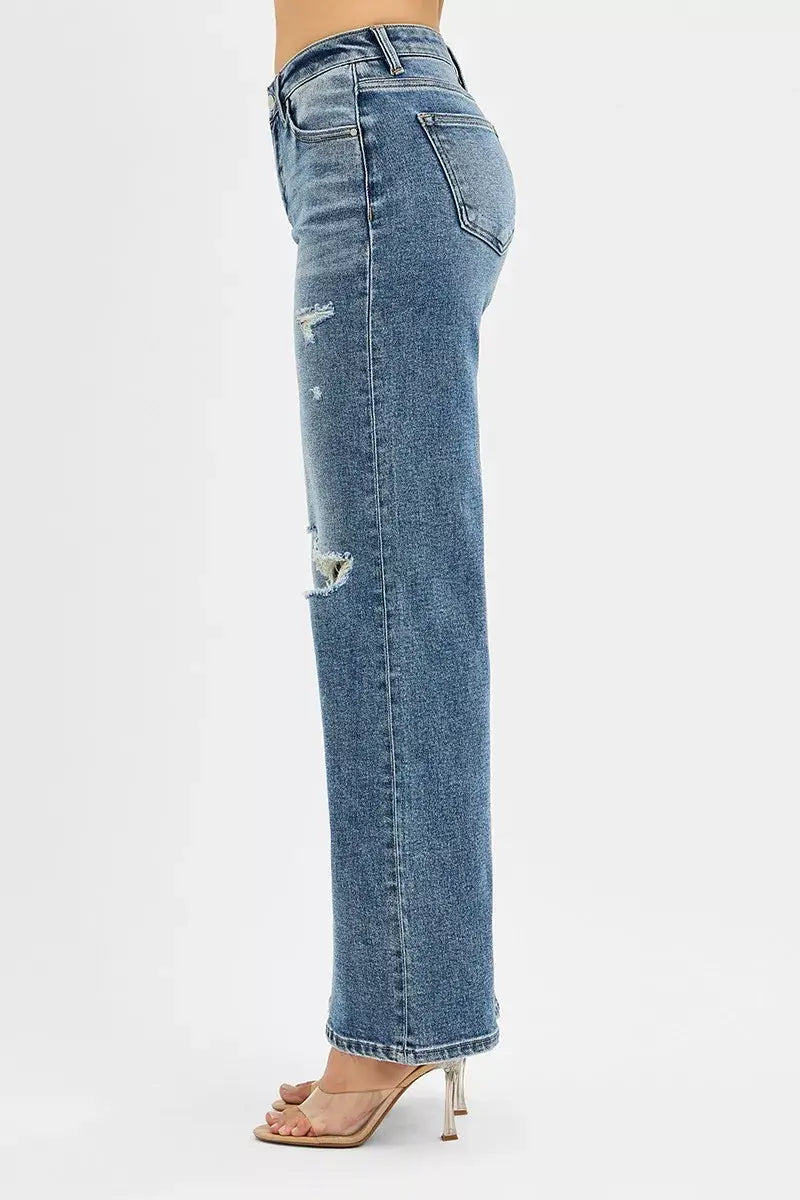 Side view of RISEN Tummy Control Mid Rise Fit Wide Jeans with distressed details and raw hem.