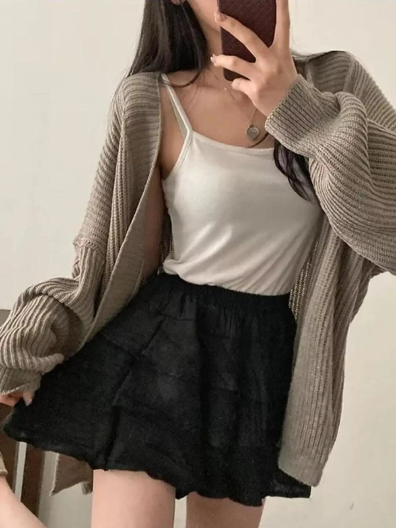 Model wearing an Open Front Oversized Knit Cardigan with a white tank top and black skirt.