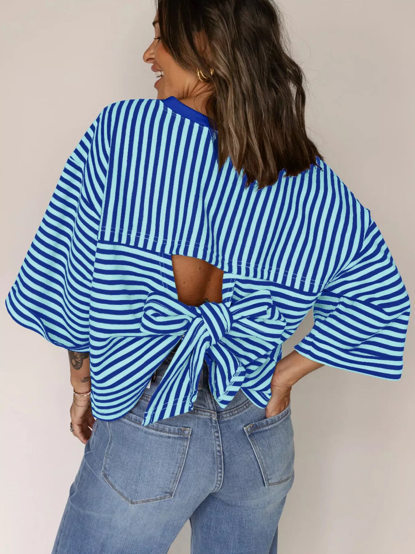 Striped Back Bow Tie T-Shirt showcasing blue and white stripes, oversized fit, and stylish bow detail on the back.