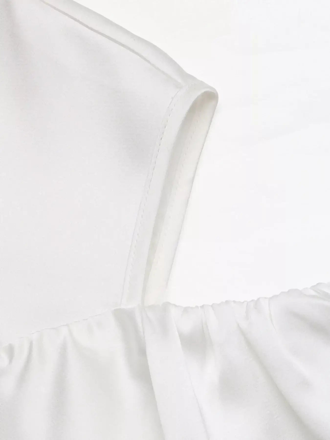 Detail of Ruffled Cold Shoulder Flounce Sleeve Blouse showcasing elegant ruffles and soft fabric texture.