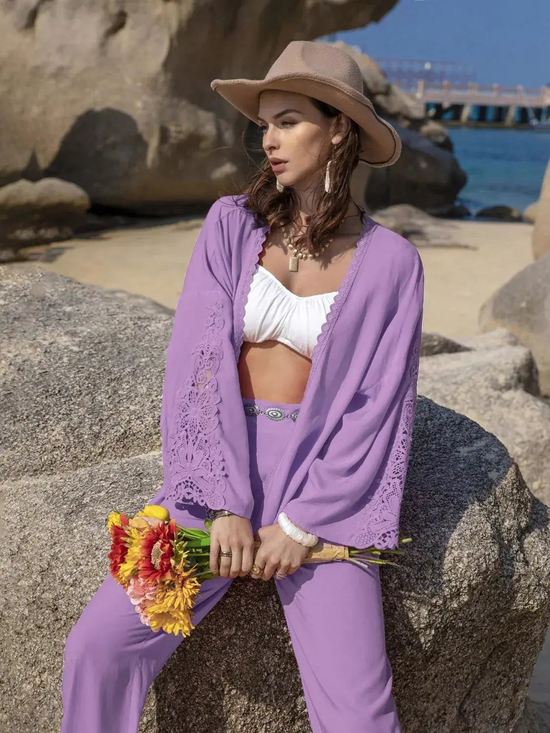 Lace Detail Open Front Cover Up and Pants Set for Women worn by model in purple on beach with hat and flowers.