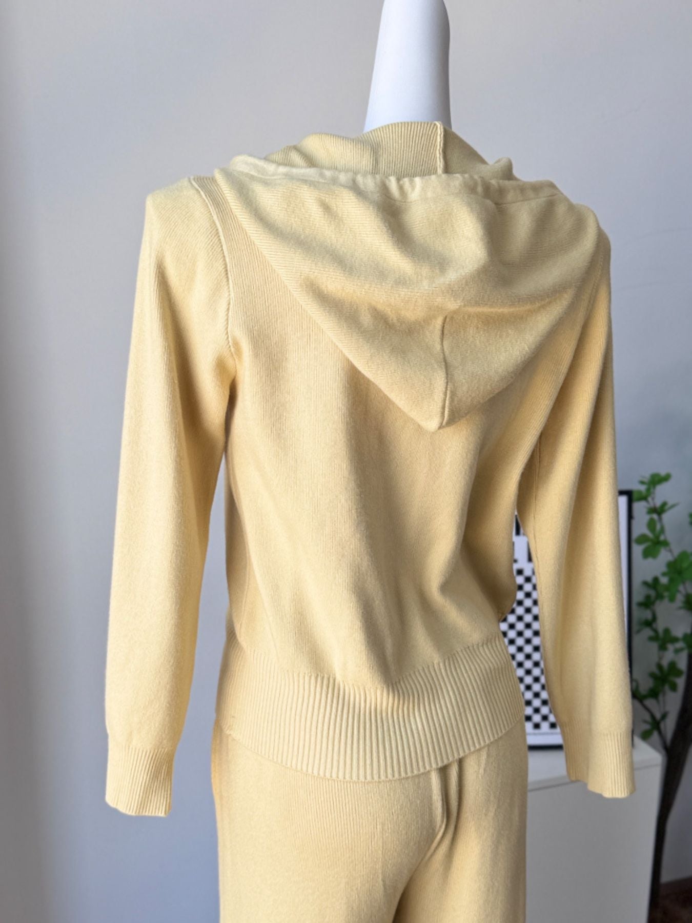 Back view of Zip Up Cardigan and Wide Leg Pants Knit Set in soft yellow, featuring a hood and ribbed hem.