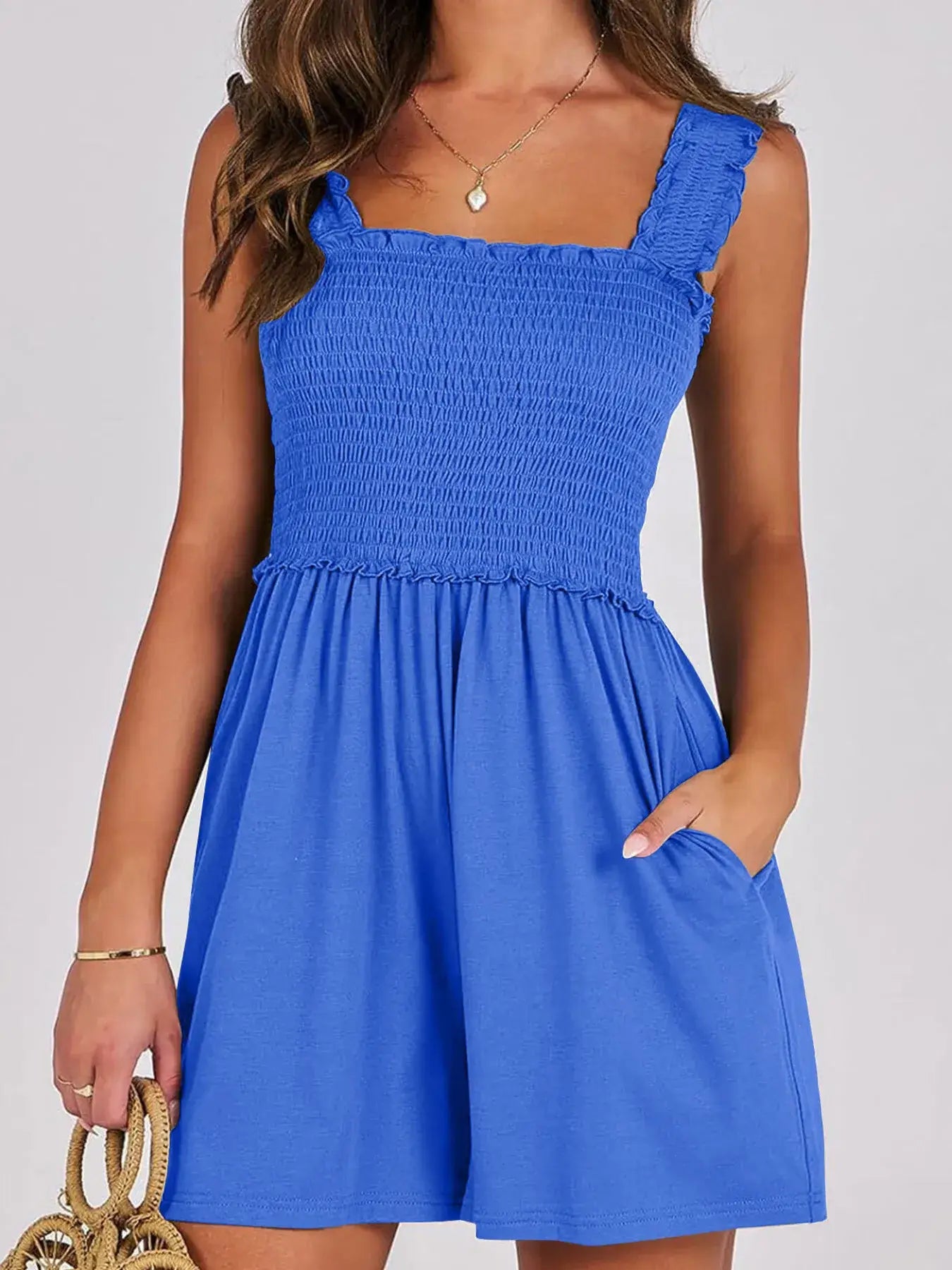 Model wearing a blue Smocked Square Neck Summer Romper with ruffled edges and pockets, perfect for summer outings.