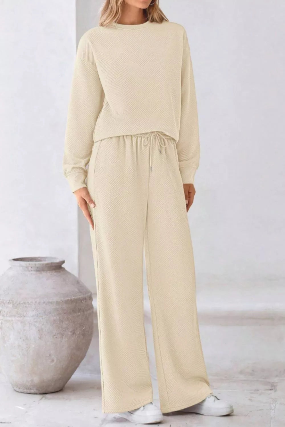 Stylish model wearing the Round Neck Long Sleeve Top and Pants Set in beige, perfect for casual outings and lounging.