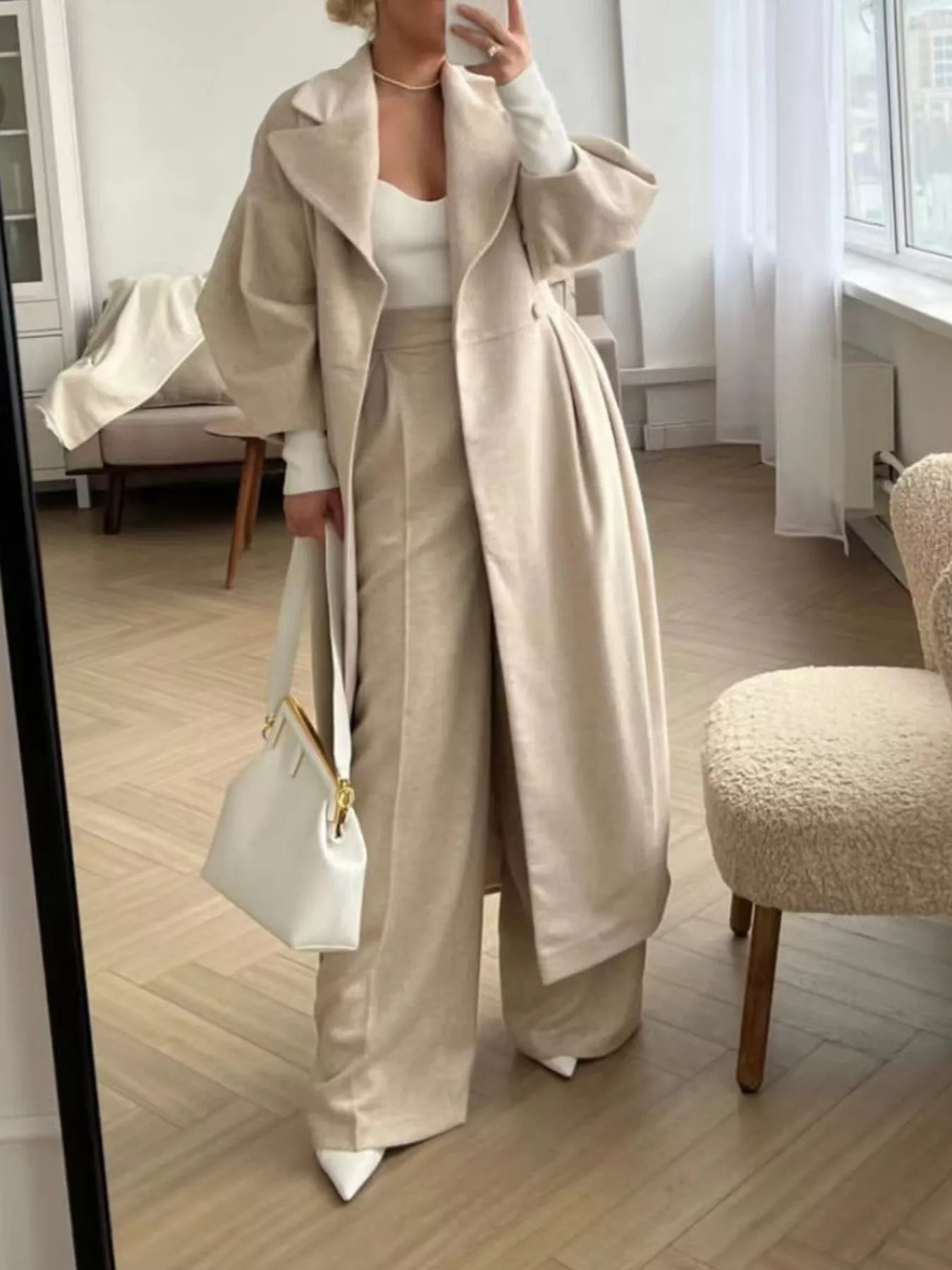 Double-Breasted Longline Coat worn over matching beige outfit, showcasing elegant tailored silhouette and stylish look.