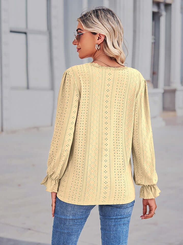 Woman wearing Eyelet V-Neck Flounce Sleeve Blouse in yellow, showing back view with flounce sleeves.