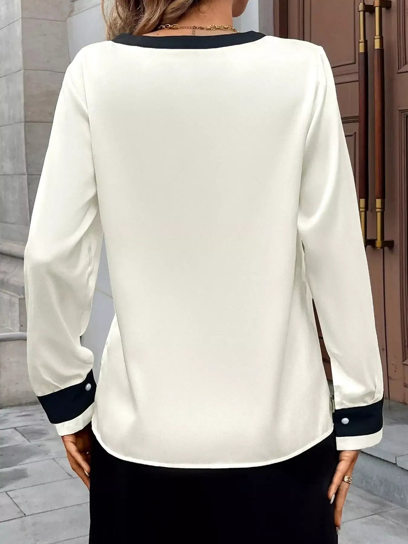 Back view of the Contrast Trim V-Neck Blouse showcasing elegant design and stylish contrast detailing.