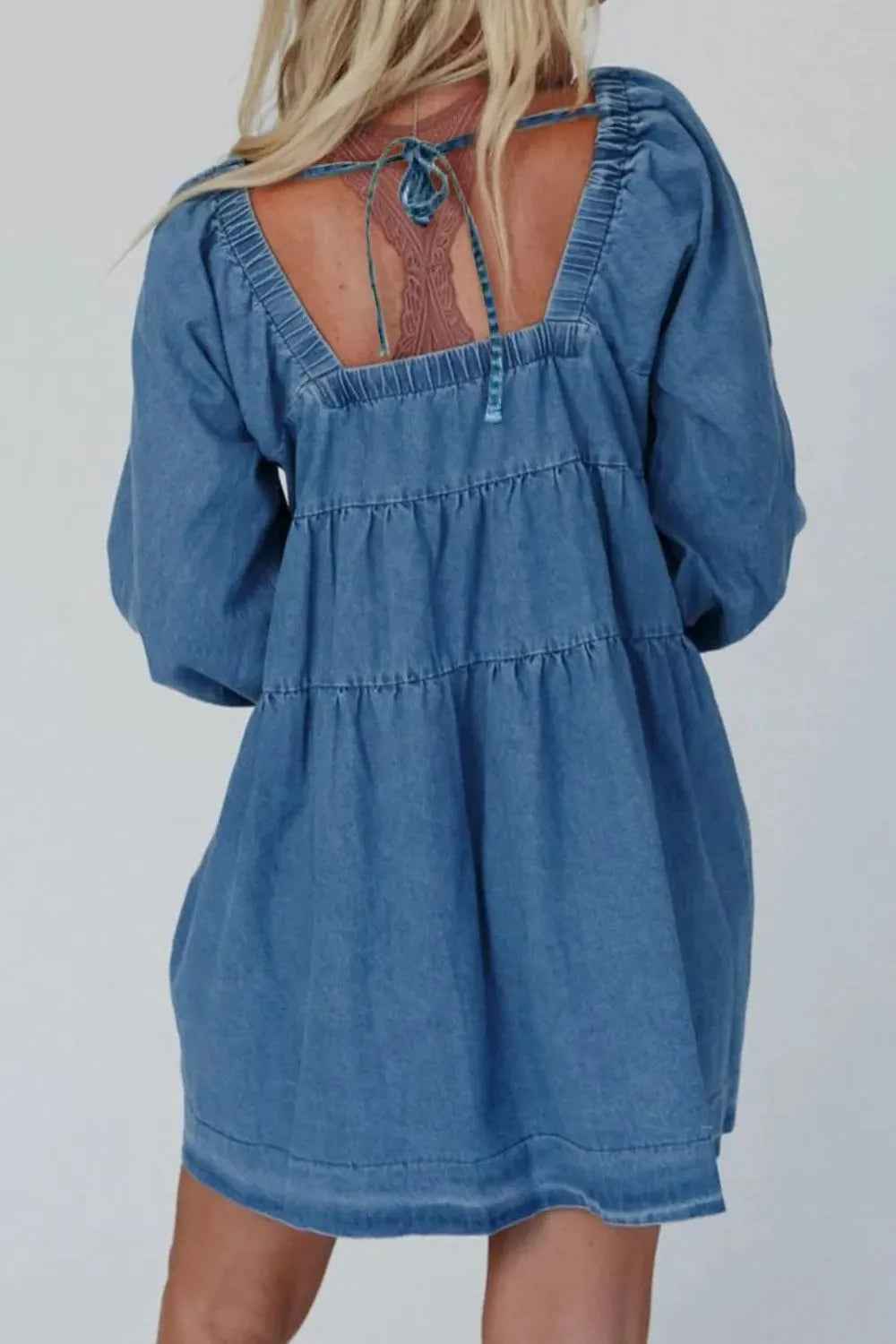 Back view of Tied Square Neck Long Sleeve Denim Dress with Pockets for women, showcasing the tied design and blue denim fabric.