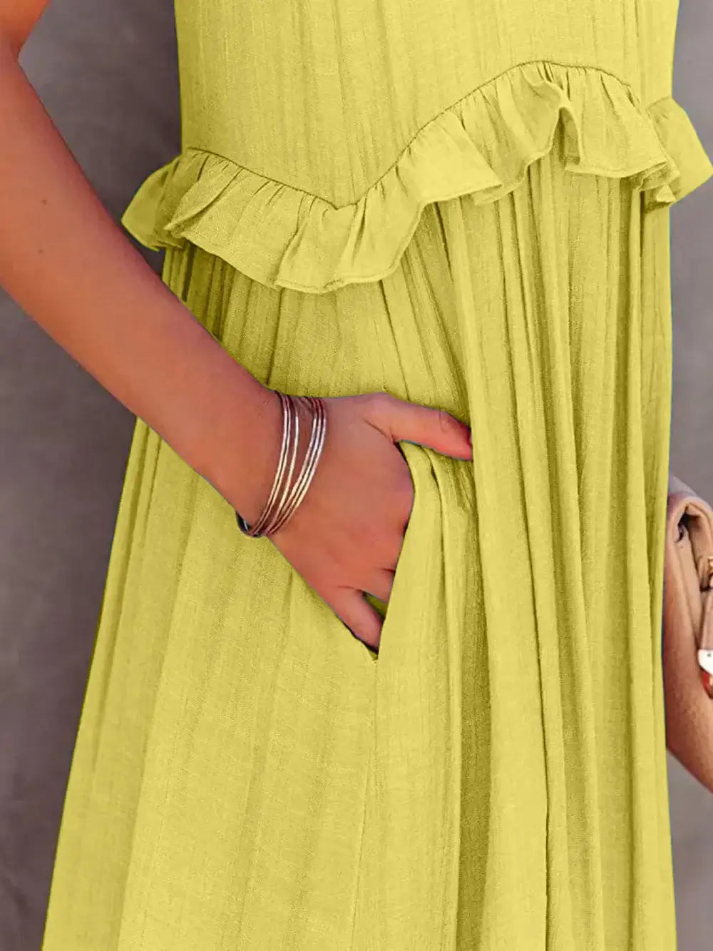 Ruffled Sleeveless Tiered Maxi Dress with Pockets detail showcasing soft ruffles and hidden pockets.