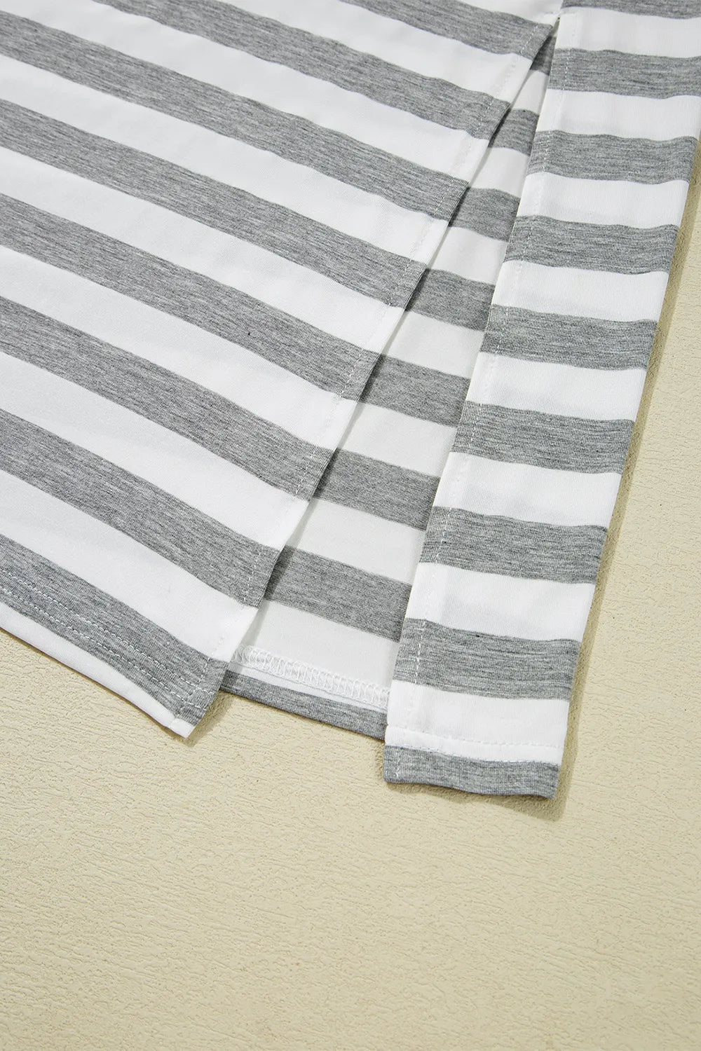 Casual Striped V-Neck Midi T-Shirt Dress showing slit detail and gray-white striped fabric.