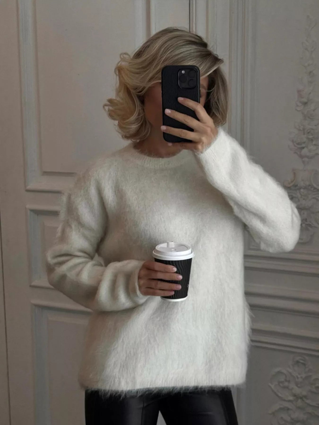 Fuzzy Round Neck Long Sleeve Sweater cozy women's pullover worn by a person holding a coffee cup in a stylish setting.