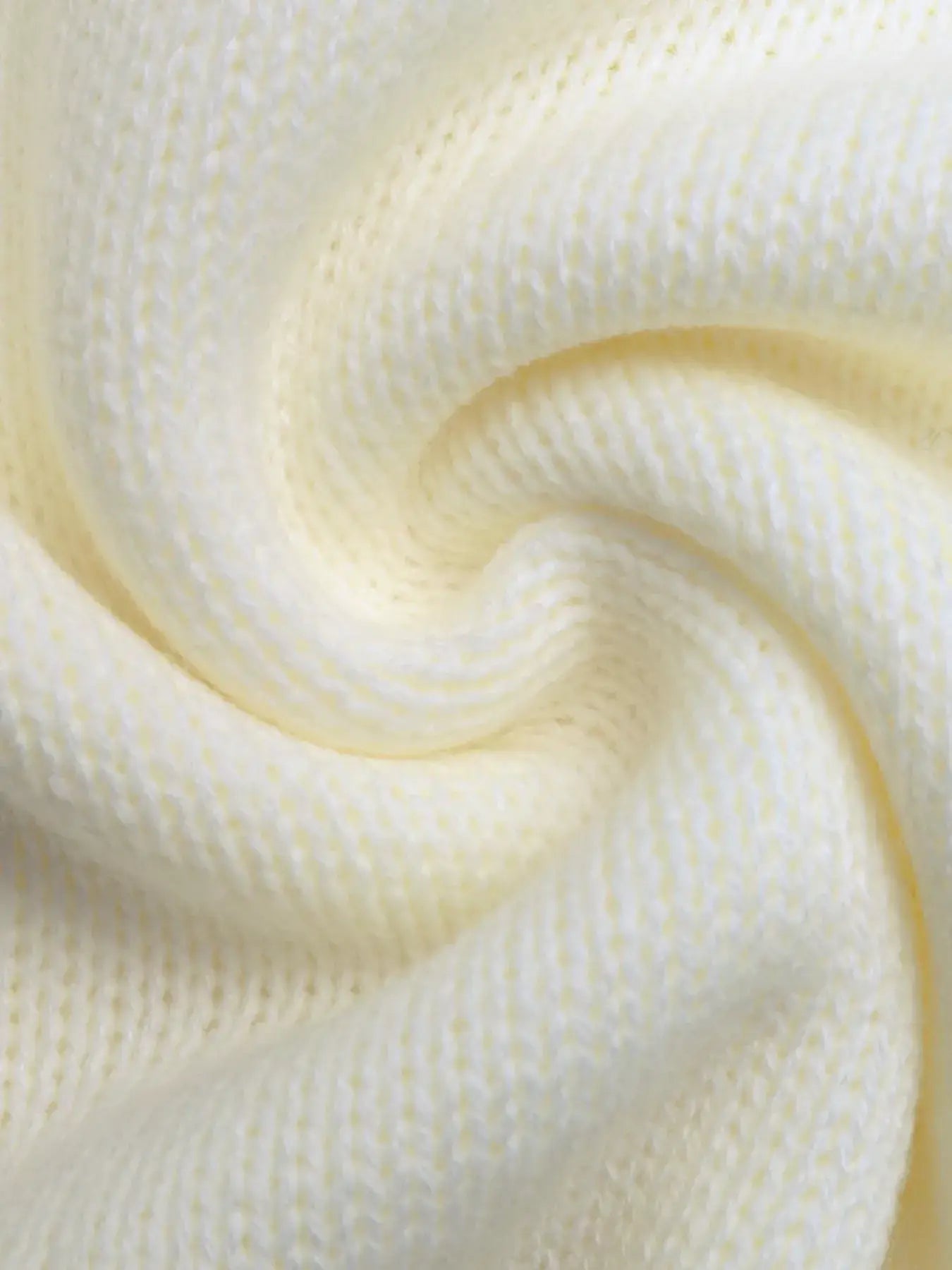 Close-up of soft, knitted fabric showcasing the texture of a Fair Isle Pattern Crew Neck Sweater for cozy winter style.