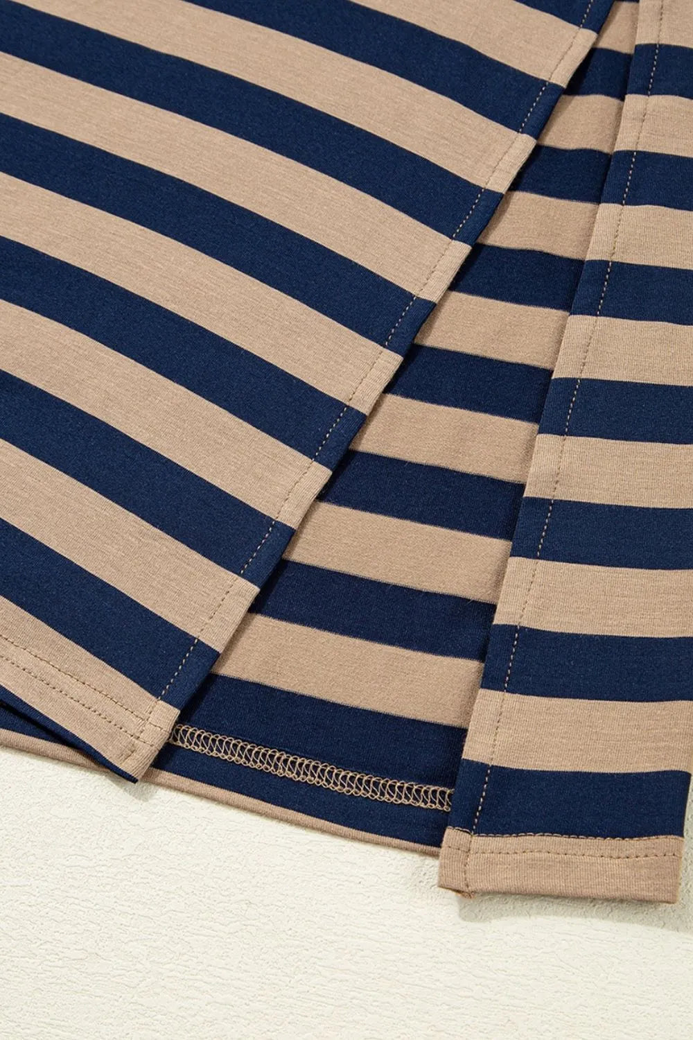 Casual Striped V-Neck Midi T-Shirt Dress close-up of fabric featuring beige and navy stripes with slit detail.