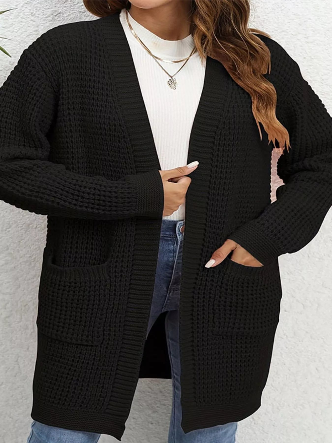 Chunky Knit Open Front Cardigan in black worn over a light top, featuring pockets and a cozy design for layered style.