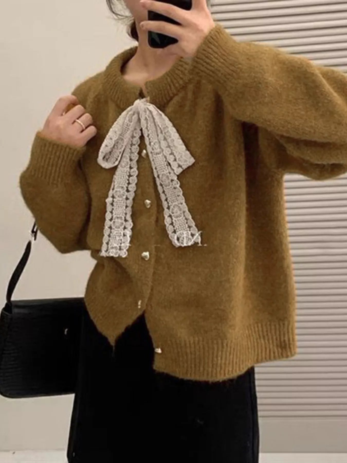 Lace Bowknot Knit Cardigan in brown with a lace bow, featuring buttons and a slightly stretchy fit for feminine everyday style.