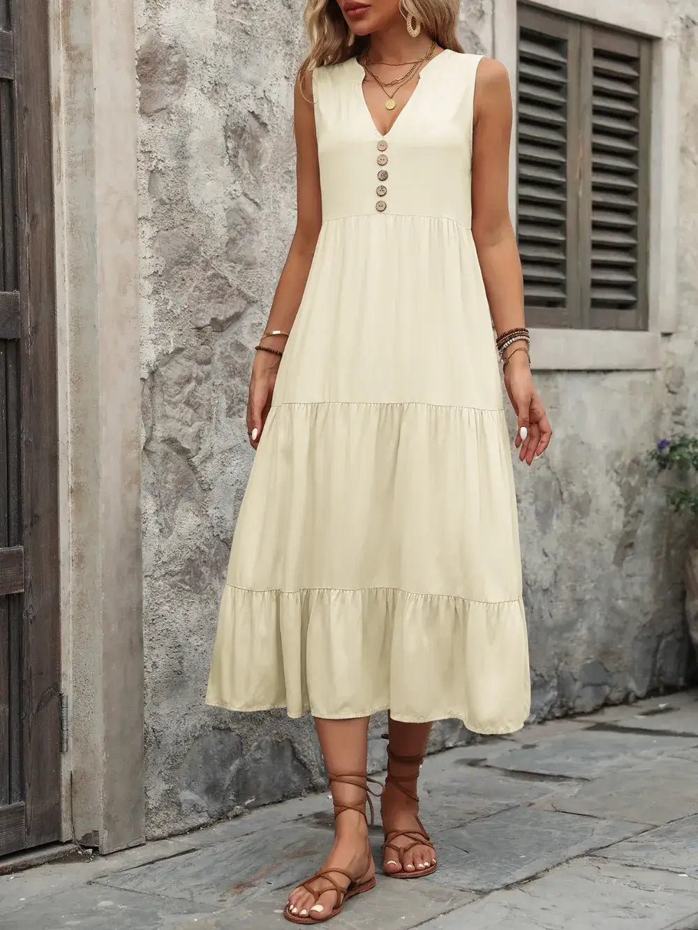 Ivy Lane Decorative Button Notched Sleeveless Dress worn outdoors, showcasing its flattering design and casual style.