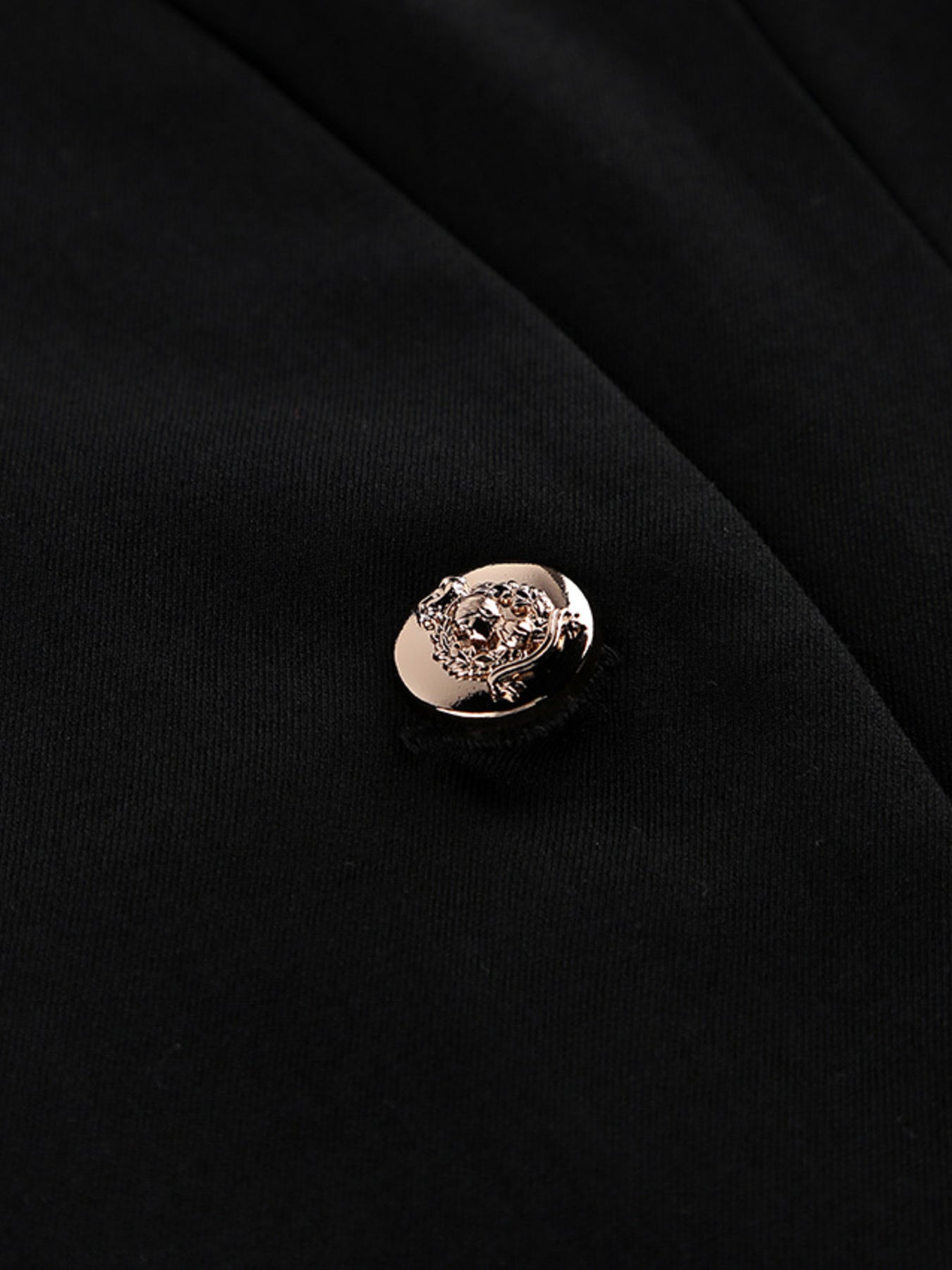 Close-up of the button detail on the Pleated One Button Blazer Dress, showcasing elegant design and craftsmanship.