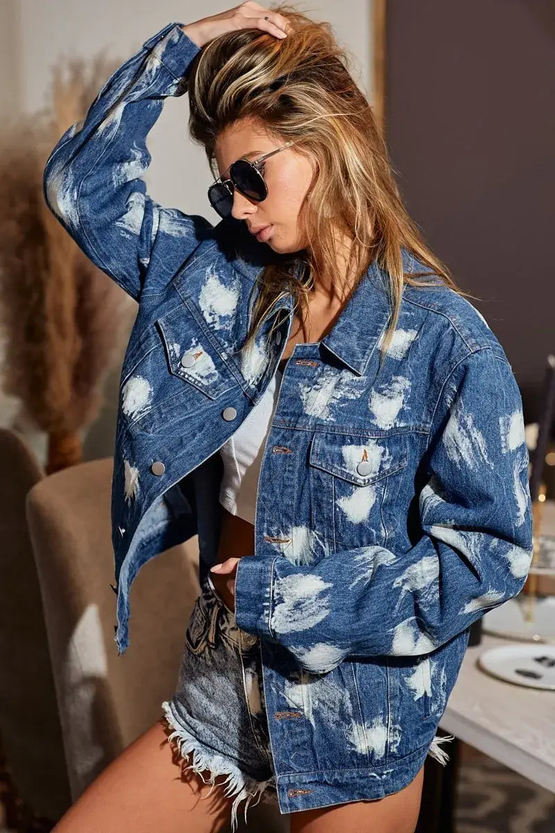Woman wearing a BiBi washed tie dye denim jacket, styled with sunglasses, showcasing a casual look.