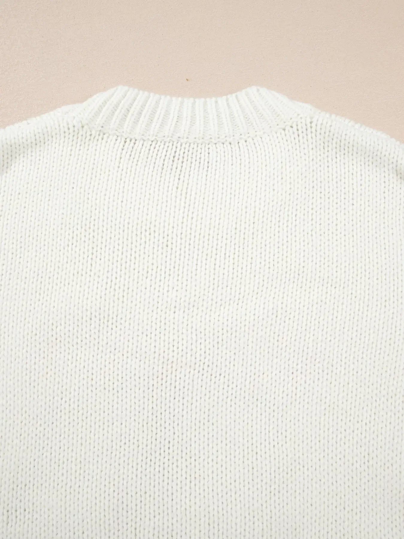 Back view of the cozy knitted fabric of the embroidered bow boots graphic drop shoulder sweater.