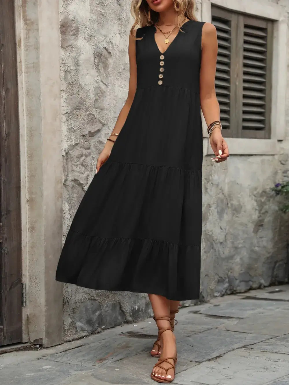 Ivy Lane Decorative Button Notched Sleeveless Dress in black with decorative buttons and a flowy design.