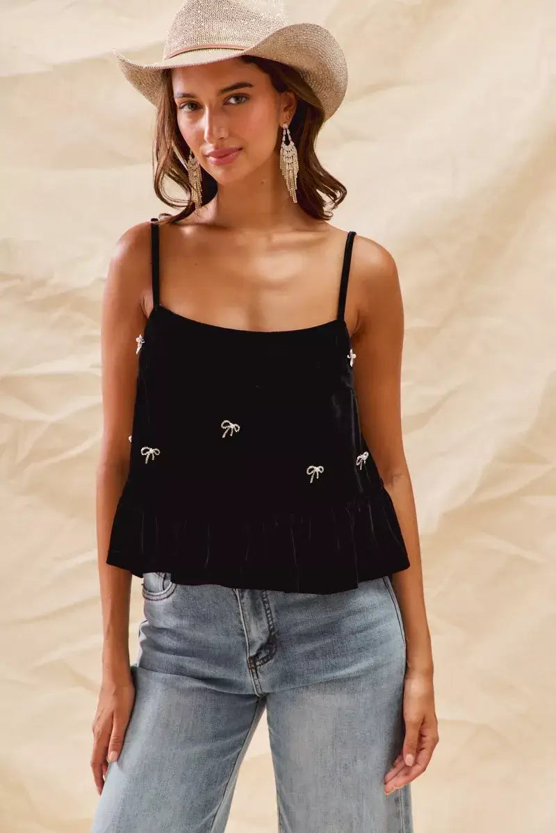 Model wearing SO ME Holiday Velvet Ribbon Rhinestone Christmas Top with stylish cowgirl hat and denim jeans.