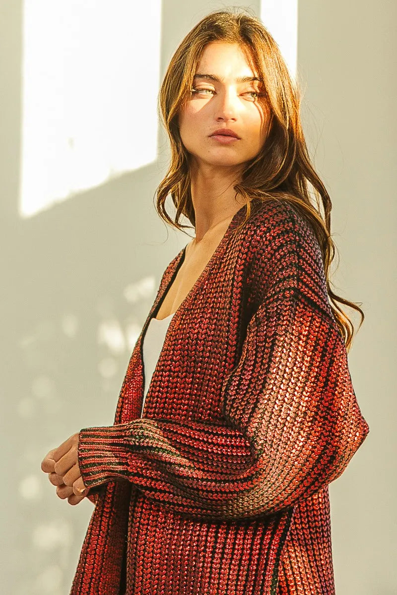 Model wearing BiBi Metallic Knit V-neck Open Sweater Cardigan in shimmering red tones, styled for a chic layered look.