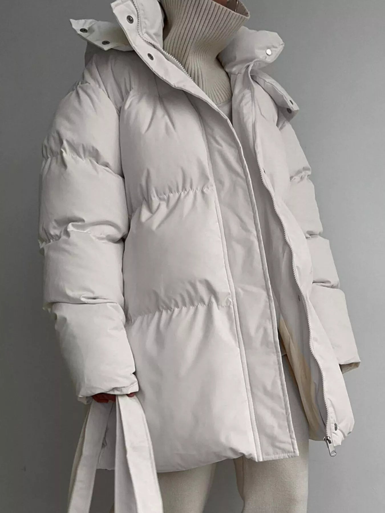 Mid Length Hooded Winter Coat Belted Warm Women Jacket in white with puffy design and pockets.