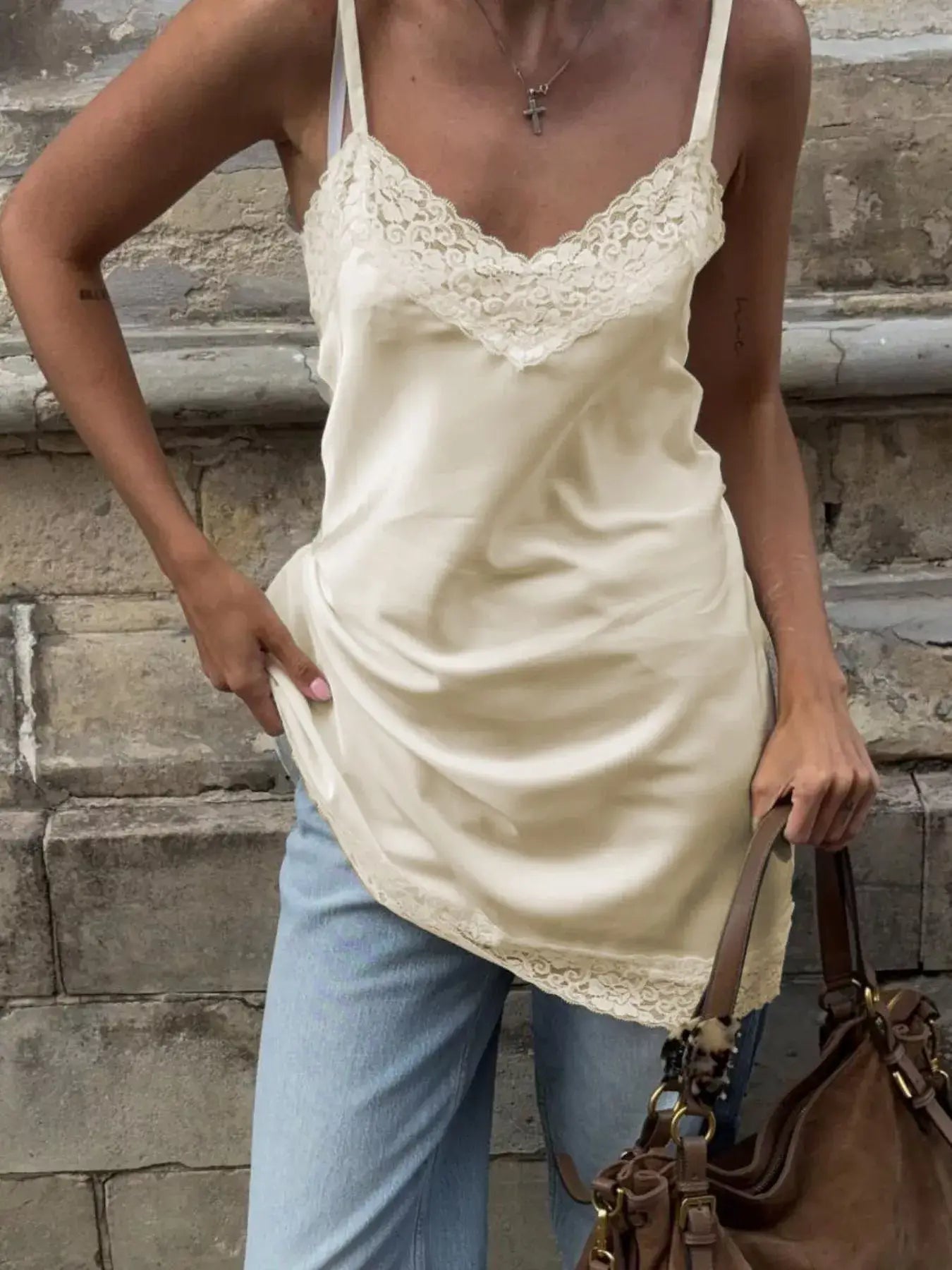 Lace Detail V-Neck Cami styled with casual jeans and a handbag, showcasing its feminine lace design and elegant look.
