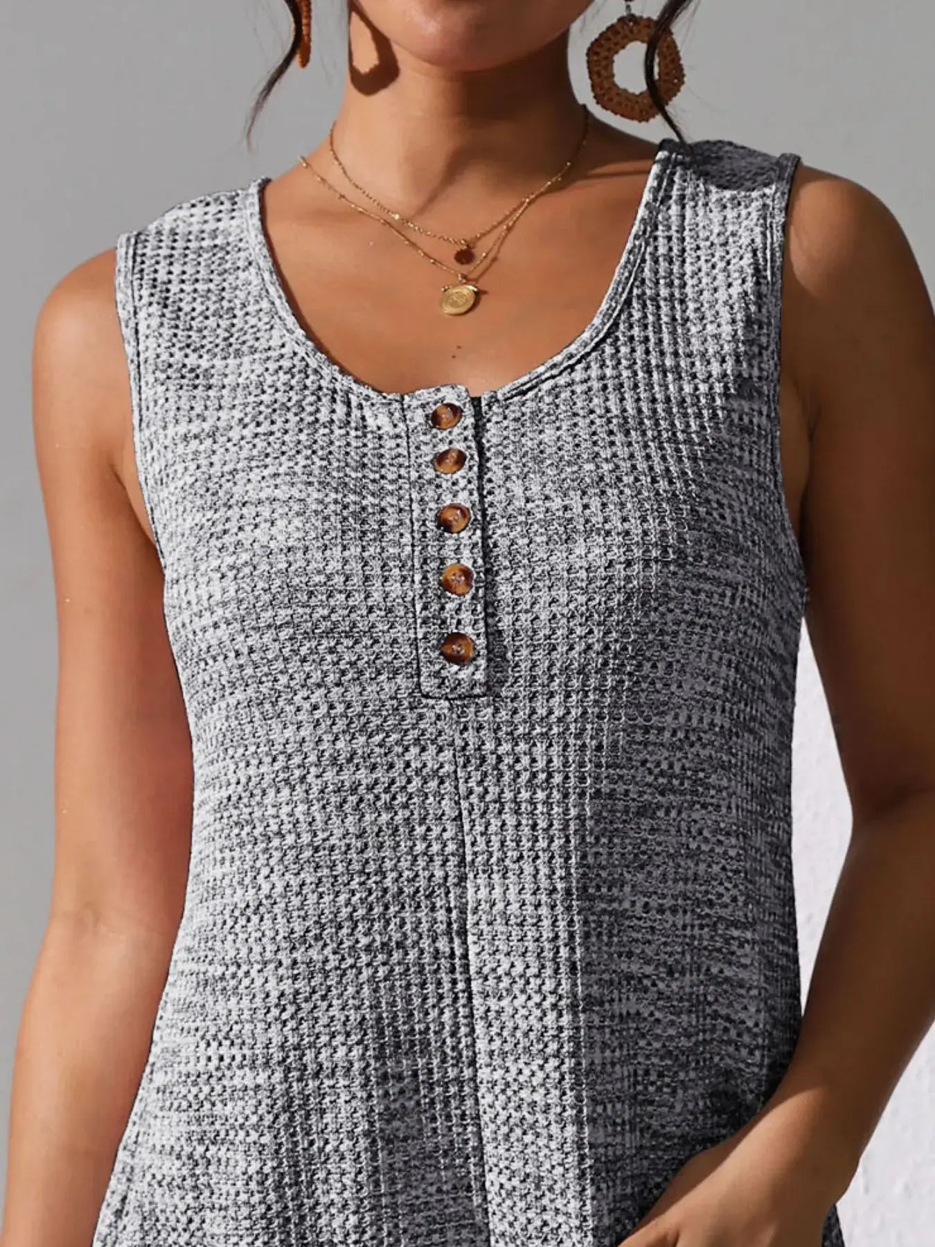 Close-up of the Full Size Button Front Romper with Pockets showcasing the button detail and textured fabric.