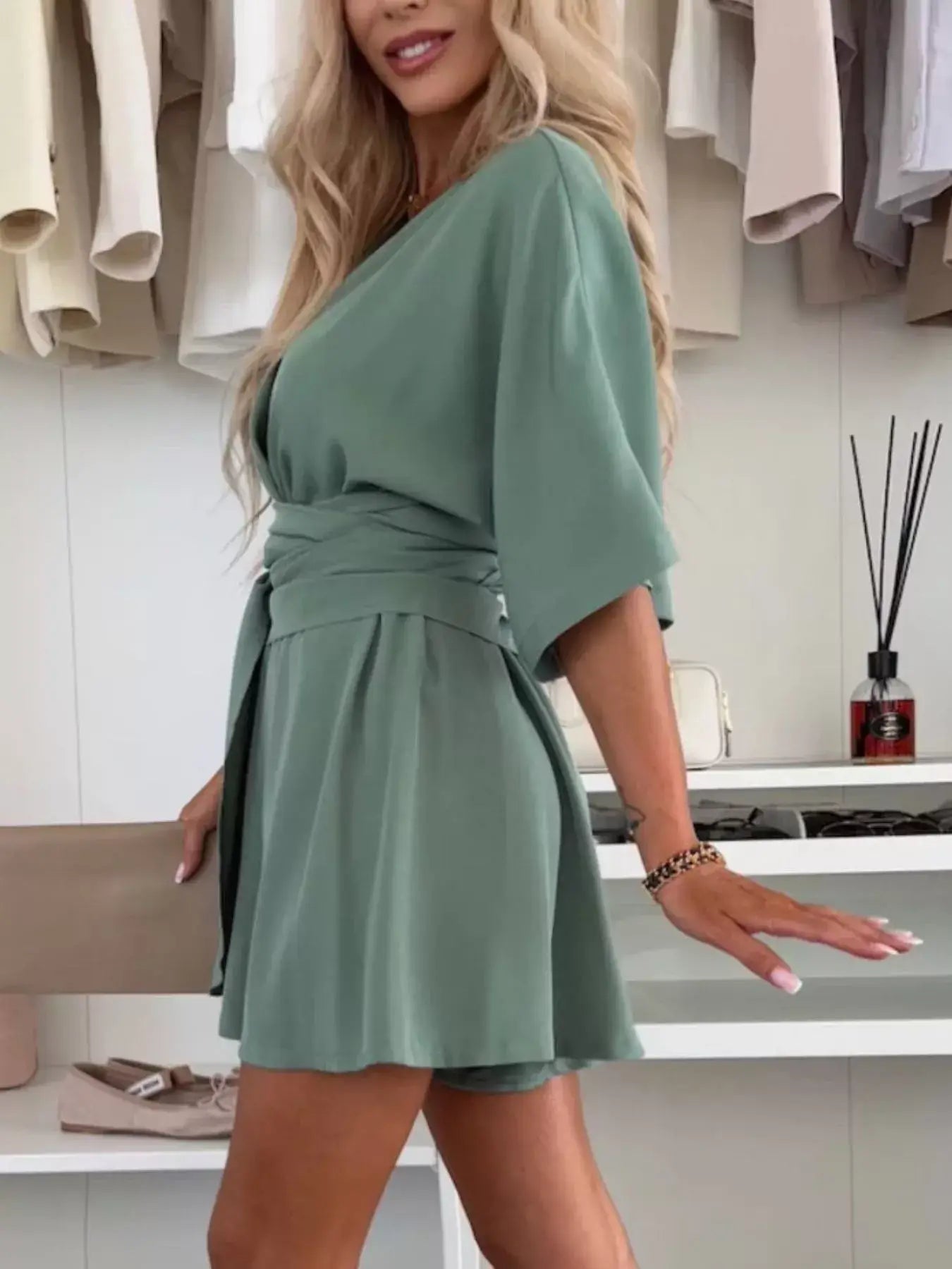 Full Size Surplice Tie Waist Romper styled on model in green, featuring a relaxed fit and elegant surplice neckline.