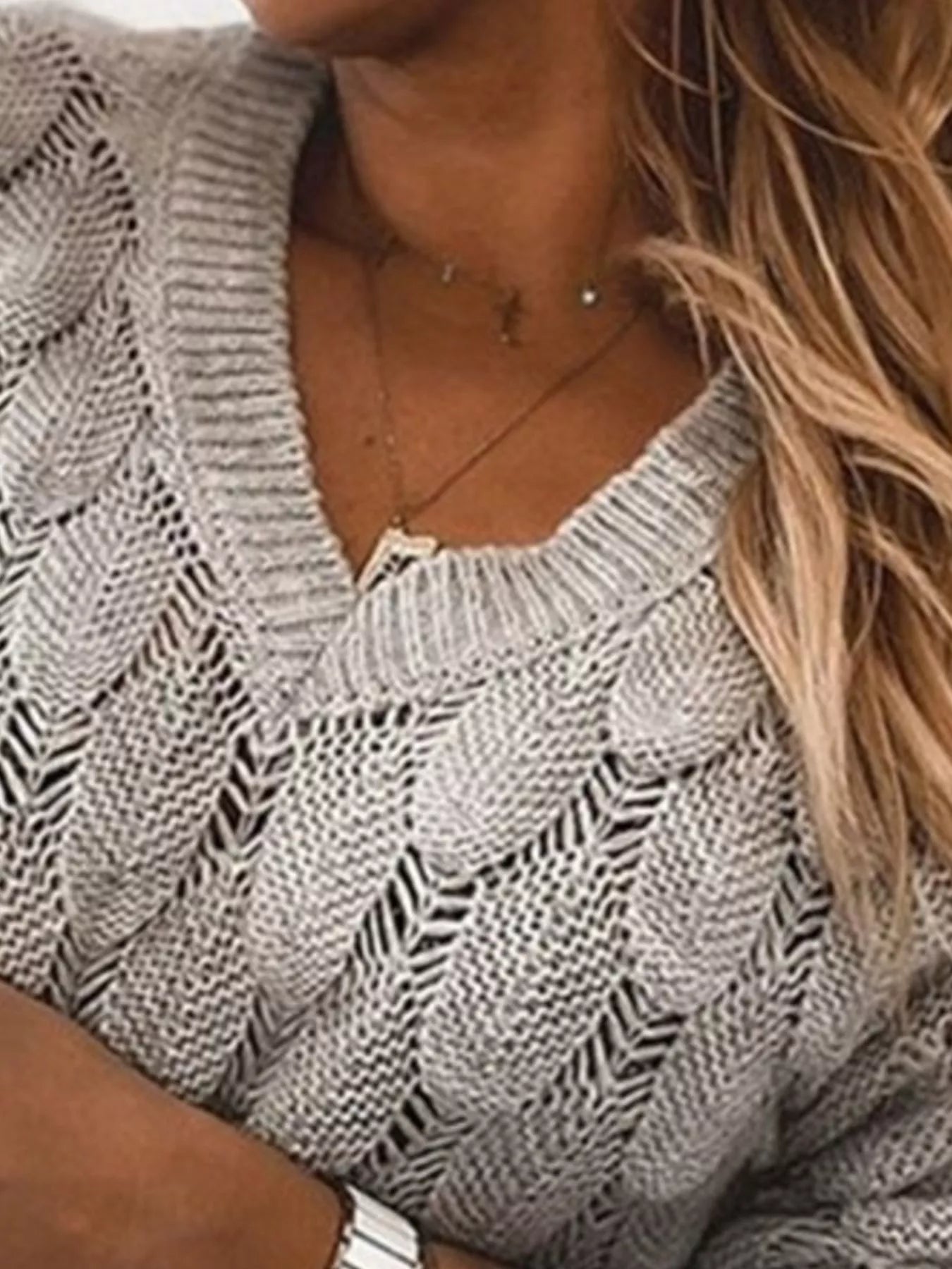 Close-up of a woman wearing a V-Neck Knitted Sweater showcasing its openwork knit design.