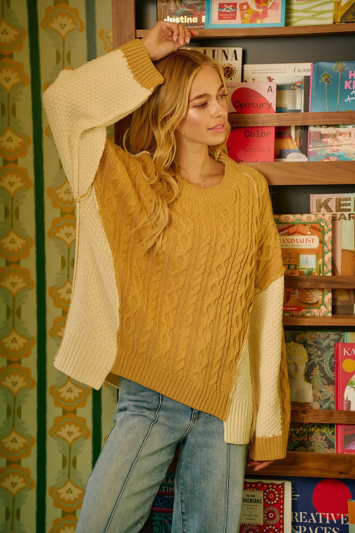 BiBi Cable Knit Hacci Combo Sweater with uneven hem and cozy fit in mustard and cream colors.