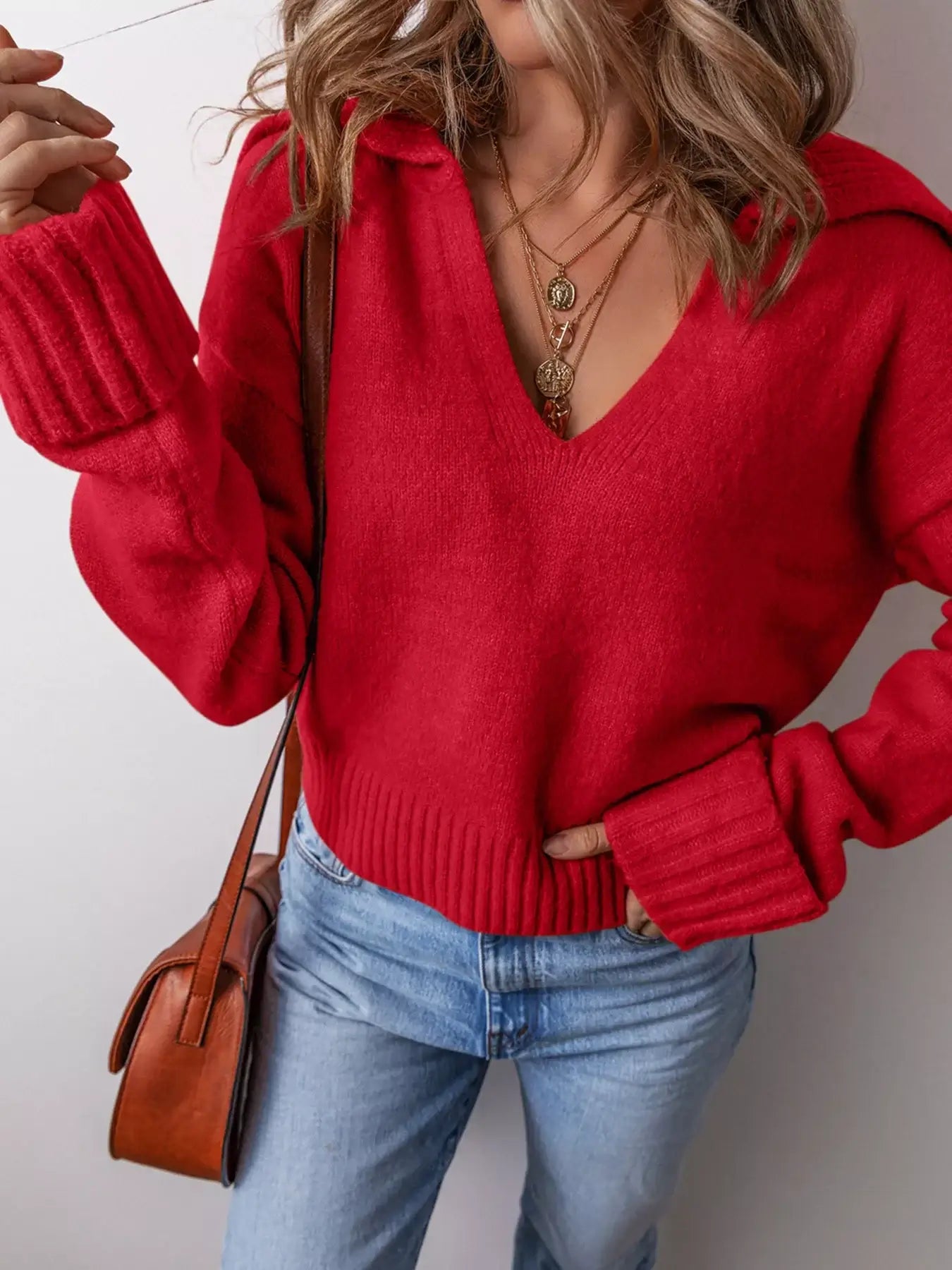 Collared V Neck Ribbed Edge Sweater in vibrant red, showcasing a flattering V-cut and ribbed edges, styled with jeans.