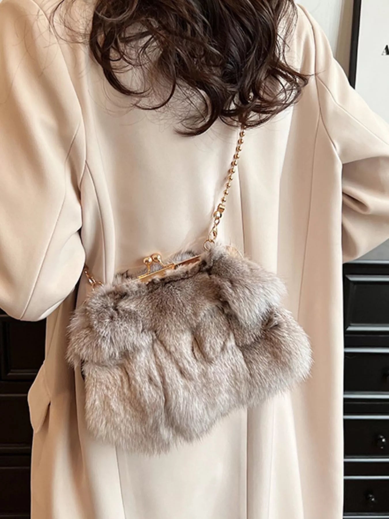 Furry Chain Crossbody Bag worn by a woman, showcasing luxurious fox fur material and trendy design.