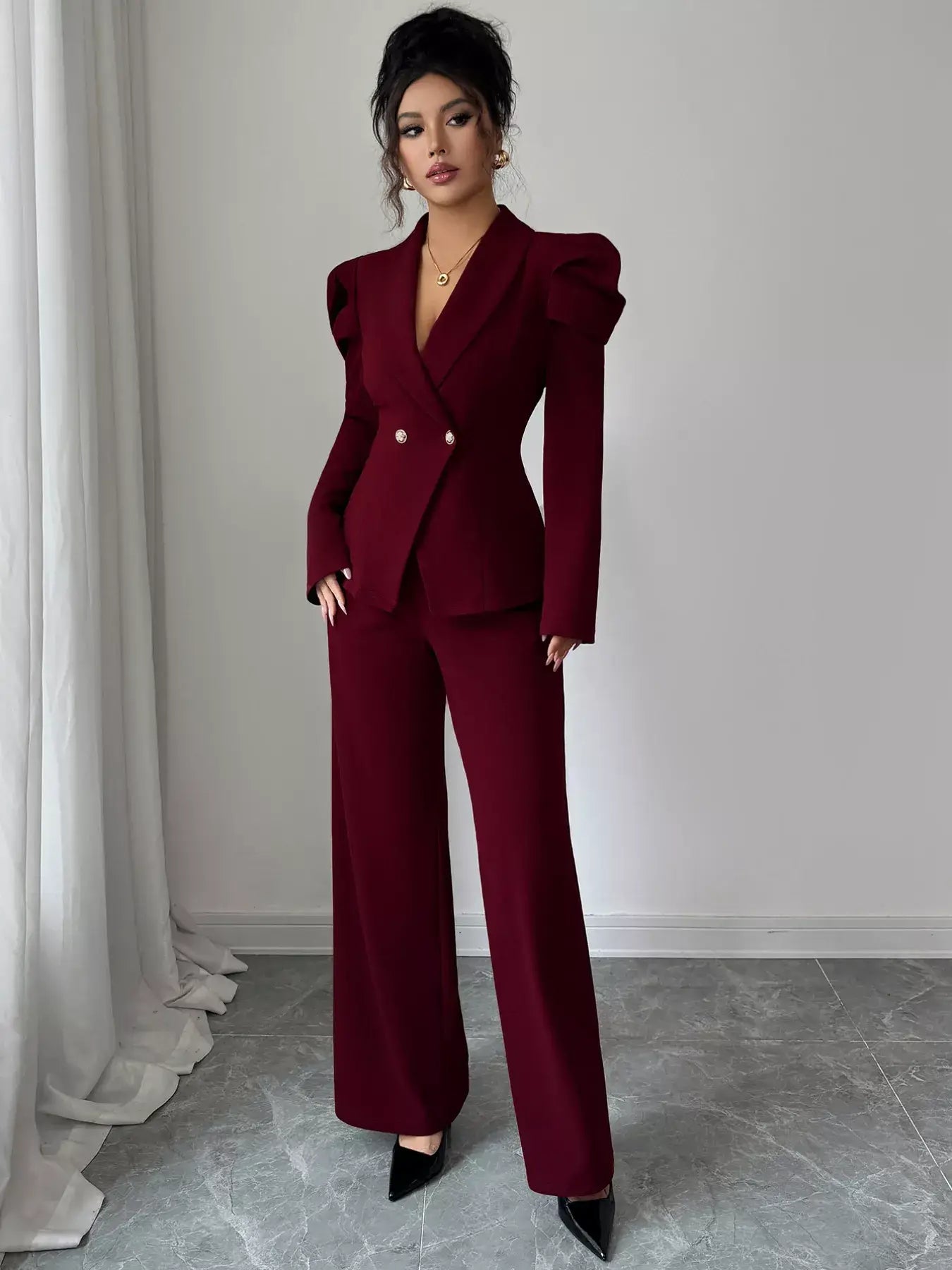 Double-Breasted Blazer and Pants Suit Set modeled in burgundy, featuring a tailored design with chic puff sleeves.