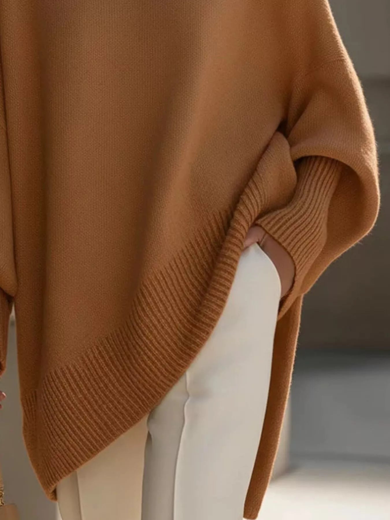Close-up of an Oversized Batwing Sleeve Knit Sweater for Women in warm brown color, showcasing ribbed texture and loose fit.