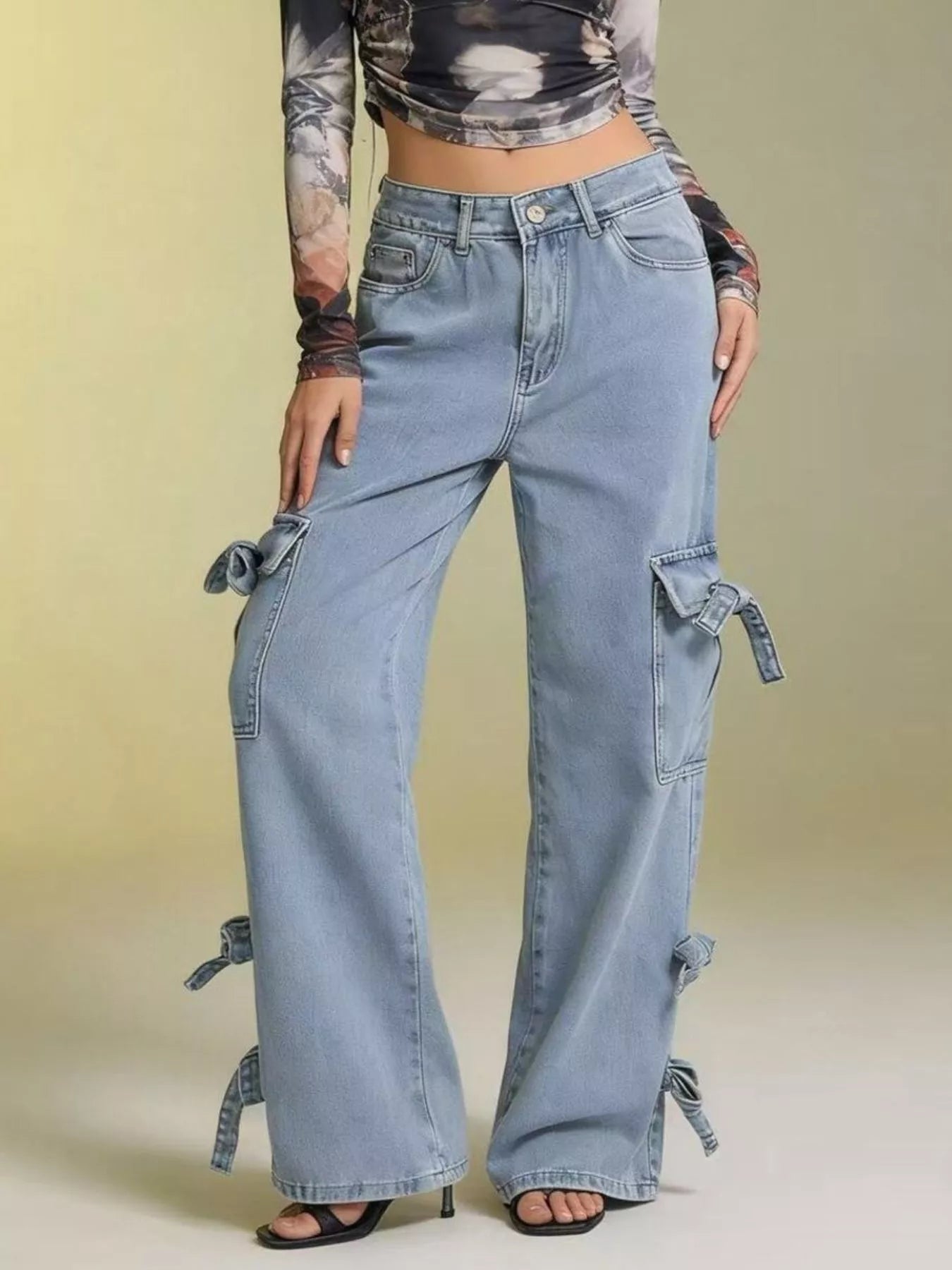 Woman wearing Bow Wide Leg Jeans with pocketed details and relaxed fit against a light background.