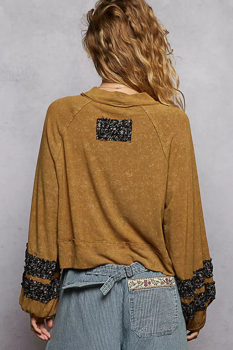 Back view of POL print patch round neck balloon sleeve cropped top showcasing its unique patch design and balloon sleeves.